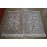 Two cream ground rugs with end tassels - 67" x 39.5" Please note descriptions are not condition
