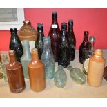 Group of sixteen stoneware and glass bottles relating to Heathfield and Waldron Please note