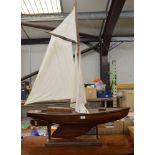 Wooden model of a pond yacht on stand - 45" long Please note descriptions are not condition reports,