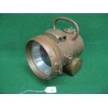 Large brass acetylene lamp with top handle and 5.5" dia centre lens. Plaque reads P&H Powell &
