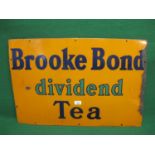 Enamel advertising sign for Brooke Bond Dividend Tea, dark blue and green letters on an orange