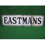 Enamel advertising sign for Eastmans, dark blue letters and Greek Key border on a white ground - 85"