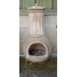 A terracotta chiminea on a metal stand - 36" tall Please note descriptions are not condition