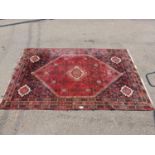 Red ground patterned rug - 3m x 2.11m Please note descriptions are not condition reports, please