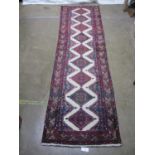 Red and white ground patterned runner - 2.90m x 0.74m Please note descriptions are not condition