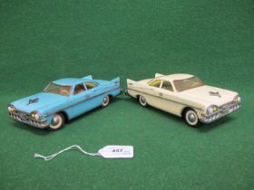 Two battery powered tinplate Sedans with different steering mechanisms and different liveries (the