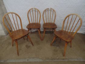 Set of four Ercol stick back kitchen chairs Please note descriptions are not condition reports,