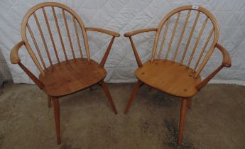 Pair of Ercol open elbow chairs having hooped stick backs Please note descriptions are not condition