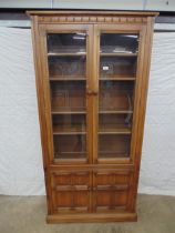 Glazed Ercol bookcase having four adjustable shelves over two cupboard doors - 38" x 77.5" Please