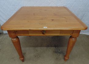 Pine kitchen table having rounded corners, single drawer and standing on turned legs - 39.5" x 39.5"