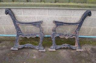 Pair of iron garden bench ends with animal head finials and each marked Regent Please note