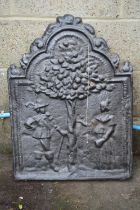 Cast iron fire back, having arched top and decorated with figures beneath a tree - 20.75" x 28.5"