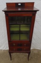 Mahogany glazed cabinet having single door over two drawers, standing on square tapering legs -