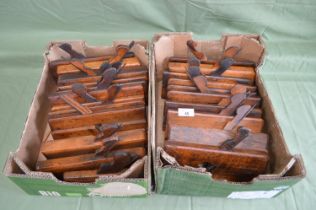 Two boxes containing twenty two wooden moulding planes Please note descriptions are not condition