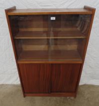 Mid century glazed bookcase having single shelf over two sliding doors - 30" x 47.25" Please note