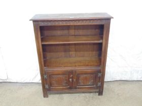 Oak open fronted bookcase with one shelf over two carved cupboard doors - 34" x 11" x 43" (RT23)