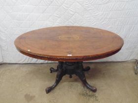 Inlaid oval tilt top looe table on central column leading to four carved splay legs - 53" x 39" x