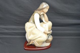 Lladro figure of classic Water Carrier, number 13525 standing on wooden base, with original box -