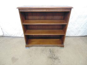 Oak open fronted bookcase with two adjustable selves and standing on bracket feet with later added