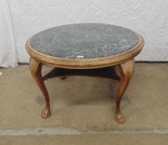 Circular marble top two tier table with carved wooden surround and standing on cabriole legs