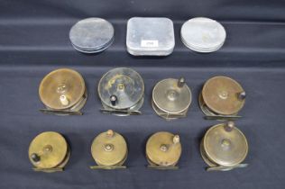 Group of seven un-gramed brass fishing reels together with an Allcocks reel and three flycases