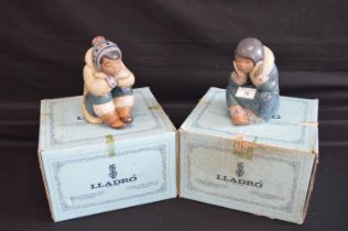 Two Lladro figures of Eskimo Children in seated position, numbers 2158 and 2159 - 6.5" and 6.75"