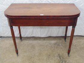 19th century mahogany fold over tea table with inlaid frieze, standing on turned legs and
