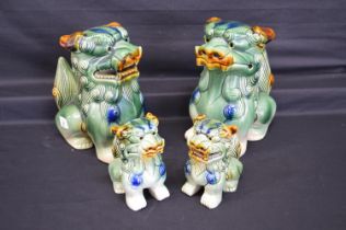 Pair of late 20th century green glazed ceramic figures of Dogs of Foe - 10" tall together with a