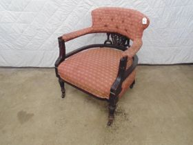 Mahogany framed tub armchair with red and gold upholstery to seat, arms and back, standing on turned