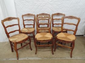 Set of six French rush seated chairs with shaped bar backs and carved cresting rails, seat fronts