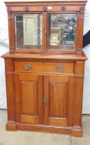 Mahogany mirror backed display cabinet having single drawer over two cupboard doors, standing on