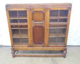 Oak display cabinet with two bar glazed doors and standing on a stretchered base - 49" x 12" x 48.5"