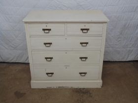 White painted chest of three long graduated and two short drawers with brass handles, standing on
