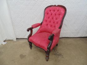 19th century mahogany frame button back armchair in red upholstery, standing on turned legs ending