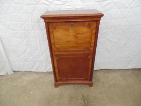 Mahogany cupboard with drop down top section and single opening door to lower section enclosing