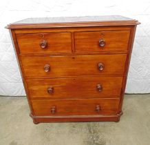 Mahogany chest of three long graduated and two short drawers with turned knob handles, standing on