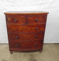Mahogany bow fronted chest of three long and two short drawers with knob handles (one knob missing),