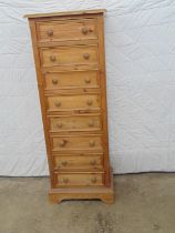 Tall pine chest of eight drawers with knob handles, standing on bracket feet - 20" x 13" x 54.75"