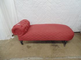 Red upholstered chaise longue standing on turned legs ending in castors - 66" x 27" x 25.5" tall