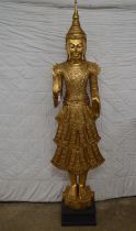 Carved wooden figure of Thai Buddha on square wooden base - approx 75" tall Please note descriptions