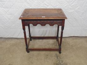 Carved oak occasional table standing on turned legs ending in castors - 26" x 18" x 28" tall (RT2)