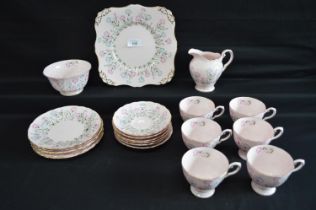 Tuscan pink ground teaset with floral pattern and gilt borders to comprise: six teacups, milk jug,