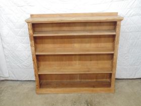 Stripped open fronted bookcase having three adjustable shelves, standing on a plinth base - 47" x