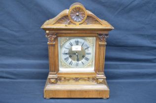 Walnut cased mantel clock with brass face and silvered chapter ring, black Roman Numerals and
