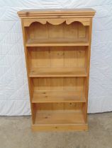 Pine bookcase with shaped frieze and three shelves, standing on plinth base - 24" x 9.5" x 48"