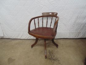 Oak swivel office chair with turned spindles and leather seat, standing on four shaped legs Please