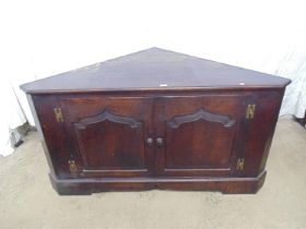 19th century oak corner cabinet with two panelled doors and knob handles opening to reveal single