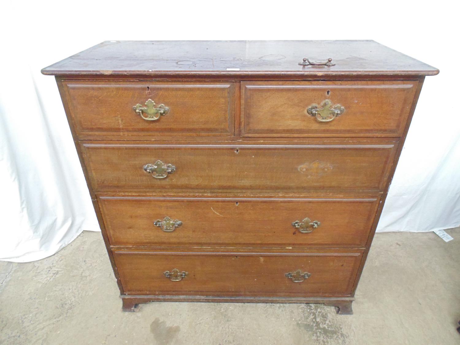 Warings oak chest of two short and three long crossbanded drawers with brass handles, standing on
