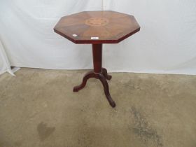 Mahogany occasional table having parquetry star decoration to top over single column leading to