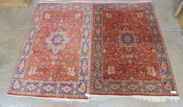 Two similar rust ground blue, cream and green patterned rugs - 2m x 1.25 and 2.08 x 1.25 (